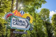 Image may contain: tree, sky, cloud and outdoor, text that says "d KENDAL CALLING #WELCOME COME TOTHE FIELDS"