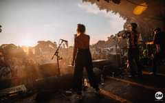 Image may contain: one or more people, people on stage, sky, concert and outdoor