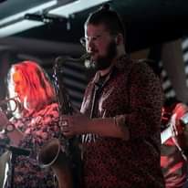 Image may contain: one or more people, people on stage, people playing musical instruments and beard