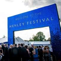 Image may contain: 1 person, sky and outdoor, text that says "WELCOME WELCOME FESTIVAL FESTIV TO THE HENLEY HEN"