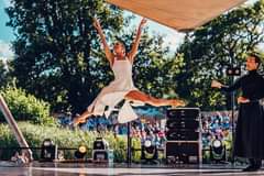 Image may contain: 2 people, people on stage, shoes, tree, outdoor and nature