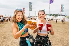 Image may contain: 2 people, people standing, drink and outdoor