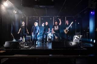 Image may contain: one or more people, people on stage, people playing musical instruments, concert and indoor