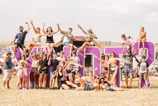 Image may contain: 6 people, people dancing, people on stage, shorts, sky and outdoor