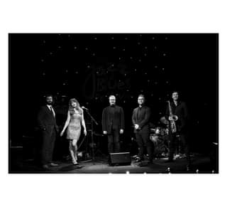 Image may contain: 5 people, people playing musical instruments, people dancing, people on stage and night