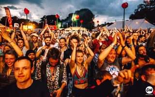 Image may contain: 15 people, people dancing, people on stage, crowd, sky, cloud and outdoor