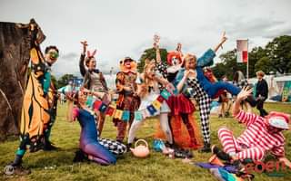 Image may contain: 6 people, people dancing, people standing, people on stage, sky and outdoor