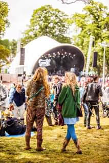 Image may contain: 1 person, dancing, standing, walking, crowd, tree, sky and outdoor