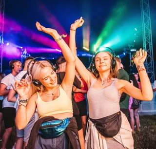 Image may contain: 3 people, people dancing, people standing, people on stage and outdoor