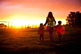 Image may contain: one or more people, people standing, sky, child, tree, outdoor and nature
