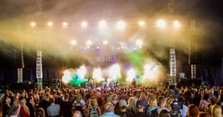 Image may contain: one or more people, people dancing, people on stage, crowd, night, concert and outdoor