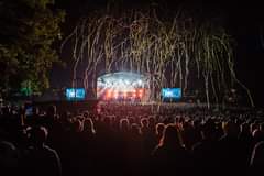 Image may contain: one or more people, people dancing, night, crowd, concert and outdoor