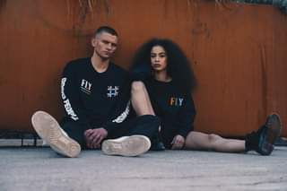 Image may contain: 2 people, people sitting and people standing