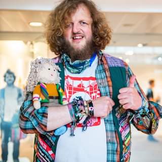 May be an image of 1 person, beard, standing and indoor