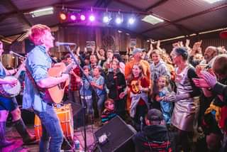 May be an image of 12 people, people playing musical instruments, people standing, guitar and indoor