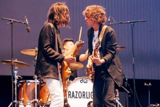 May be an image of one or more people, people playing musical instruments, people standing and guitar