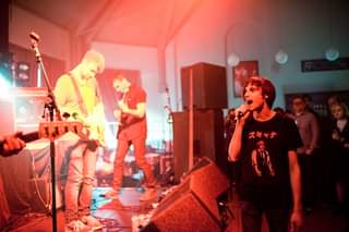 May be an image of 3 people, people playing musical instruments and people standing