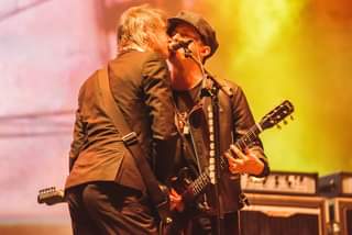 May be an image of one or more people, people playing musical instruments, people standing and guitar