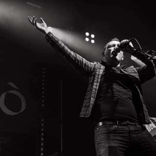 May be a black-and-white image of one or more people, people standing, people playing musical instruments and indoor