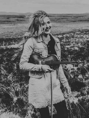 May be an image of 1 person, standing, guitar and outdoors