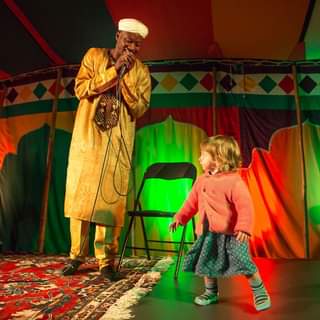 May be an image of 2 people, child, people standing, people sitting and indoor