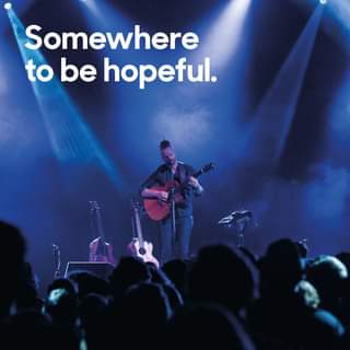 May be an image of 1 person, playing a musical instrument, guitar and text that says "Somewhere to be hopeful."