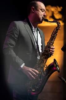 May be an image of one or more people, people playing musical instruments and saxophone