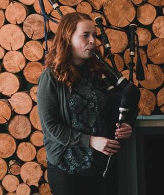 May be an image of 1 person, standing and playing a musical instrument