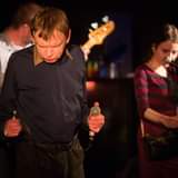 May be an image of 1 person, standing, playing a musical instrument and indoor