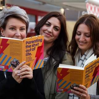 May be an image of 3 people, people standing and book