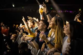 May be an image of 3 people, people standing and crowd