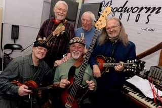 May be an image of 5 people, people playing musical instruments, people standing, guitar and indoor