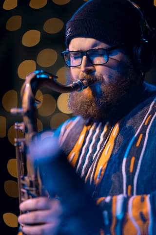 May be an image of 1 person and saxophone