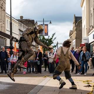 May be an image of 4 people, people walking, people standing and outdoors