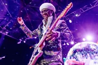 May be an image of 1 person, playing a musical instrument, standing, guitar and indoor