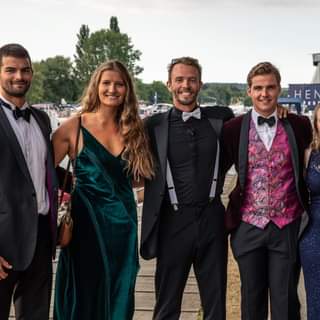 May be an image of 4 people, people standing, suit and outdoors