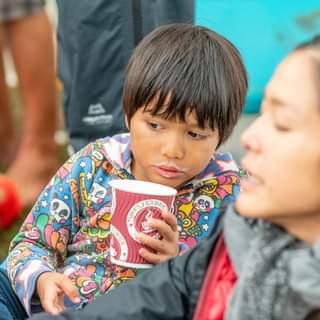 May be a close-up of child, standing and outdoors