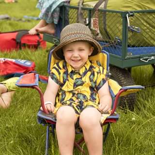 May be an image of child, sitting and grass