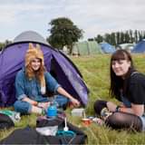 May be an image of 2 people, people camping and outdoors