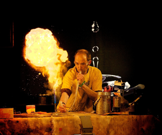 May be an image of 1 person, fire, indoor and outdoors