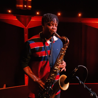 May be an image of one or more people, people playing musical instruments and saxophone