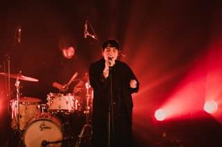 May be an image of 1 person, standing, playing a musical instrument and indoor