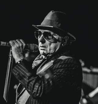 May be a black-and-white image of one or more people, people standing and people playing musical instruments