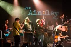 May be an image of 1 person, playing a musical instrument, standing and guitar