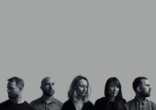 May be a black-and-white image of 5 people and people standing