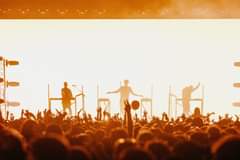 May be an image of 1 person, musical instrument and crowd