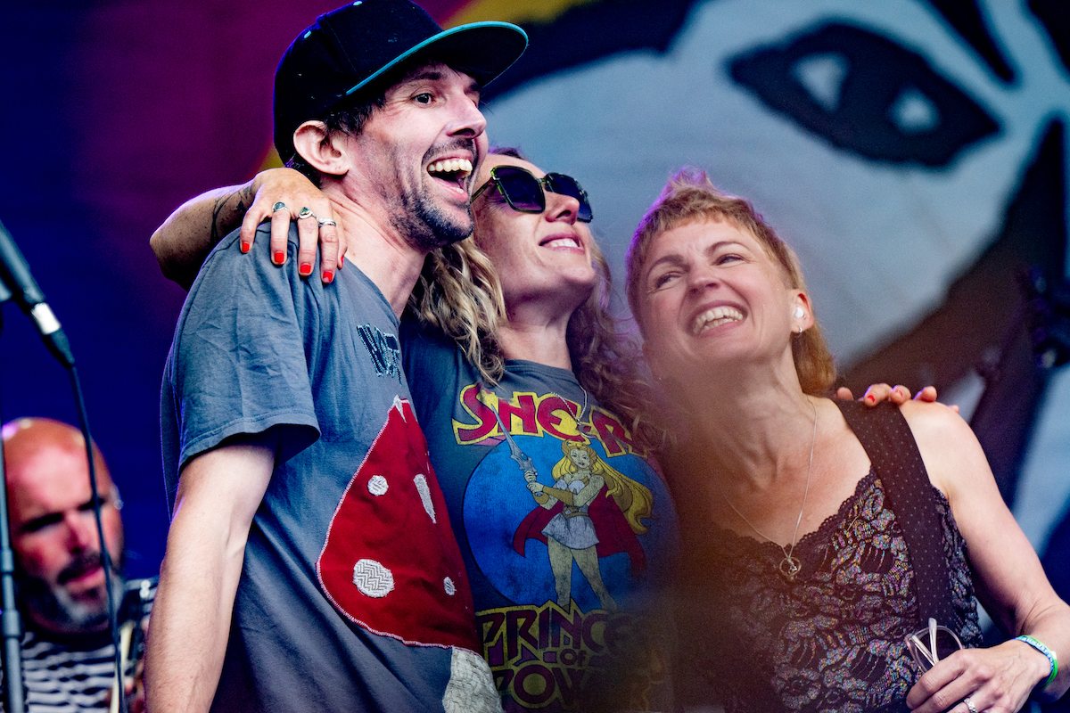 Nick Parker and the False Alarms in a group hug on stage