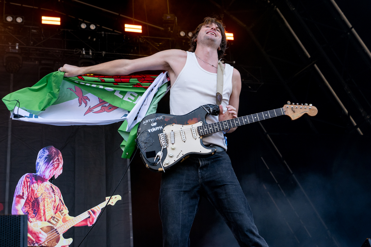 Jack Jones spreading a Welsh flag behind him