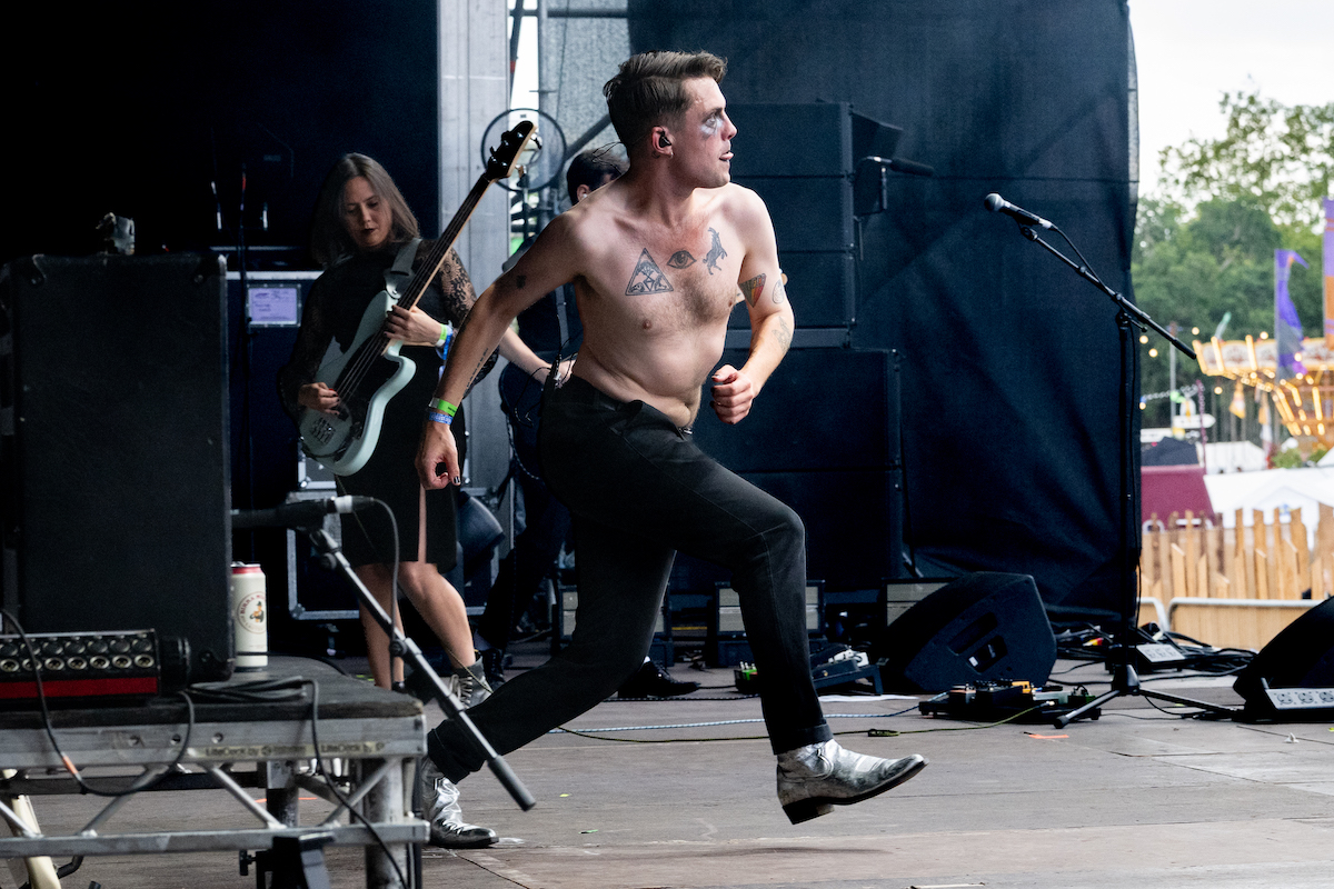 Erotic Secrets of Pompeii's shirtless singer sprinting across the stage