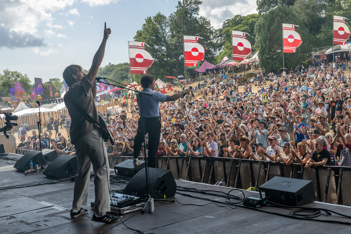 Crystal Tides from the side of the stage with a big crowd and flags